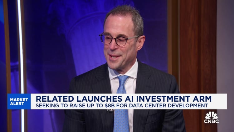 "Business professional with glasses and a striped suit smiling during an interview on CNBC, with text overlay discussing Related's launch of an AI investment arm seeking to raise up to $8 billion for data center development."
