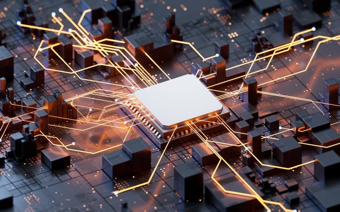 "Close-up of a microchip on a circuit board, with glowing golden connections radiating outward to black geometric structures."