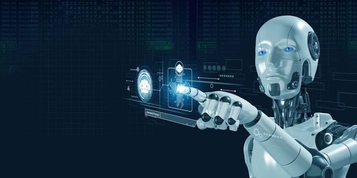 "Futuristic robot with a metallic finish, pointing at a holographic interface displaying digital icons and data against a dark technological background."
