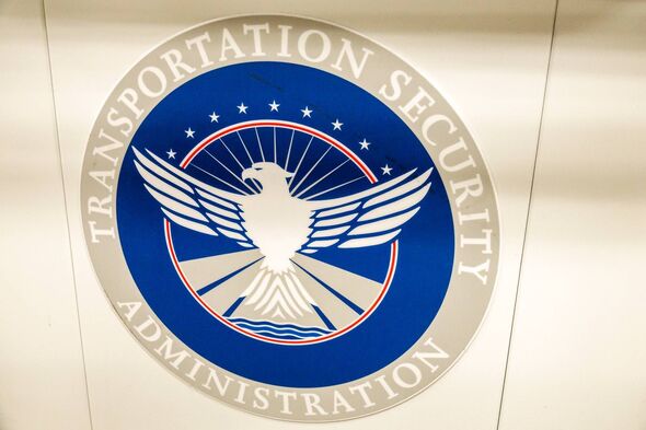 "Official seal of the Transportation Security Administration featuring an eagle with outstretched wings, set against a blue background with stars and a circular border."