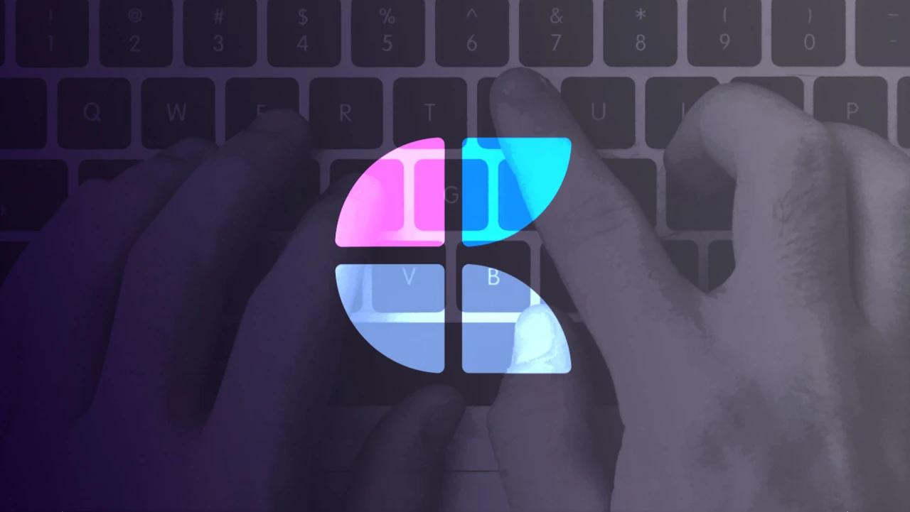 Hands typing on a keyboard with a brightly colored, four-quadrant graphic overlaid on the keys.
