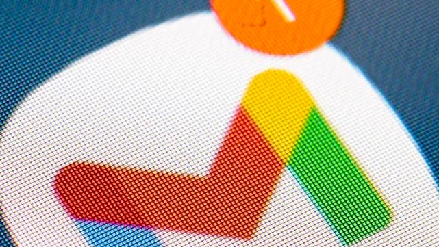 Close-up of a digital screen displaying the pixelated Google AdSense logo in red, yellow, and green, with an orange notification icon.