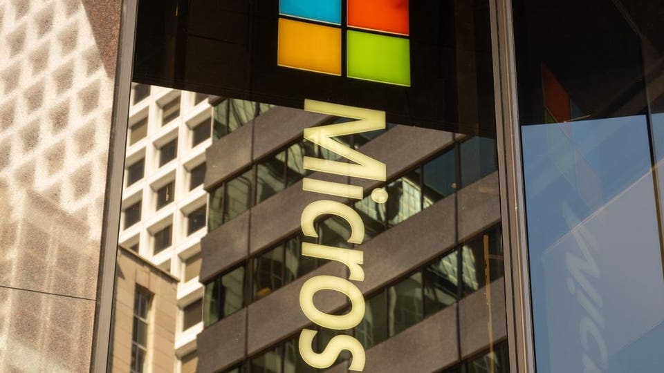 Microsoft sign with the Windows logo on a building facade.