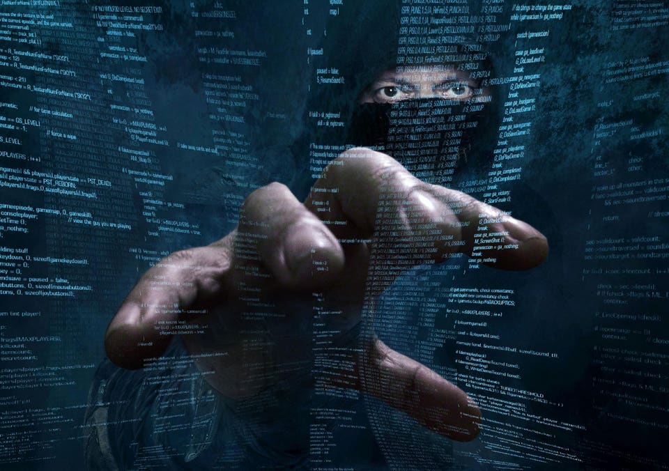 Hand reaching towards a digital display of computer code, with a person's masked eyes visible through the code.