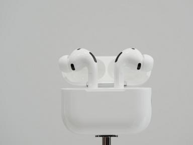 White AirPods Pro earbuds in their open charging case.
