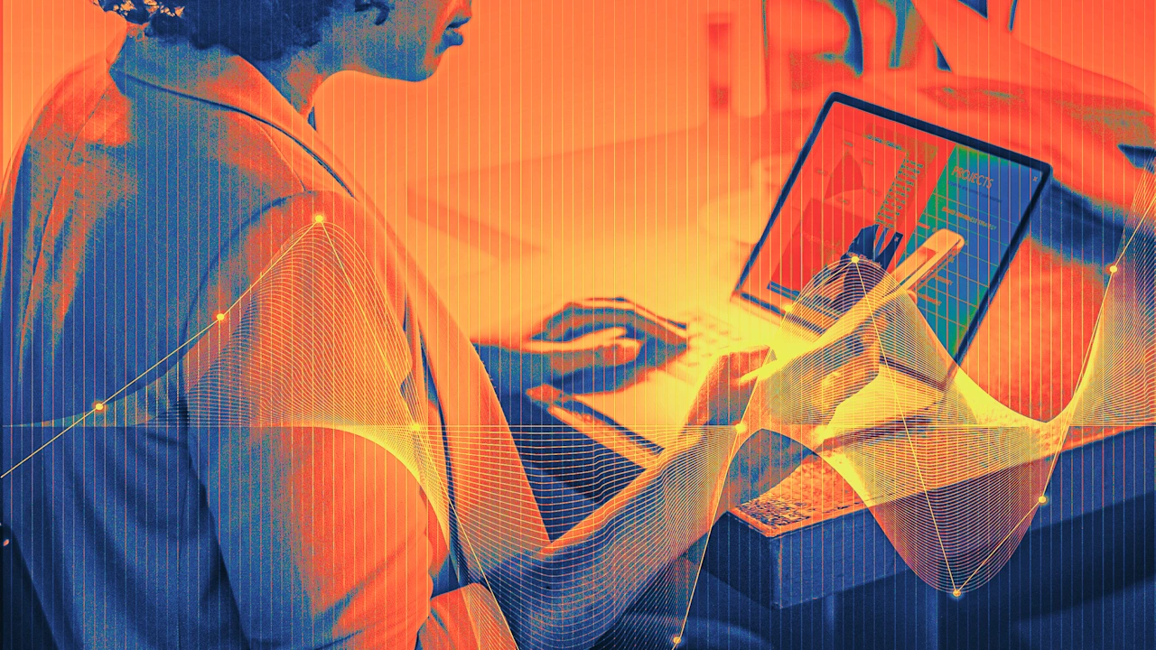 Person working on a laptop, overlaid with glowing digital graphs and grid lines.