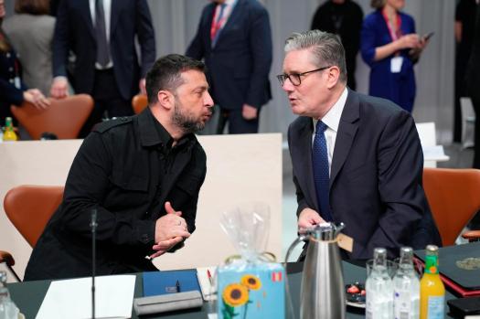 Ukrainian President Volodymyr Zelensky and British Labour leader Keir Starmer in conversation at a meeting.