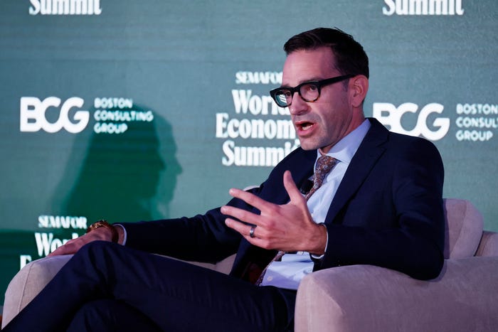 Man in a suit and glasses speaking and gesturing while seated, with 'BCG Boston Consulting Group' and 'Semafor World Economic Summit' logos in the background.