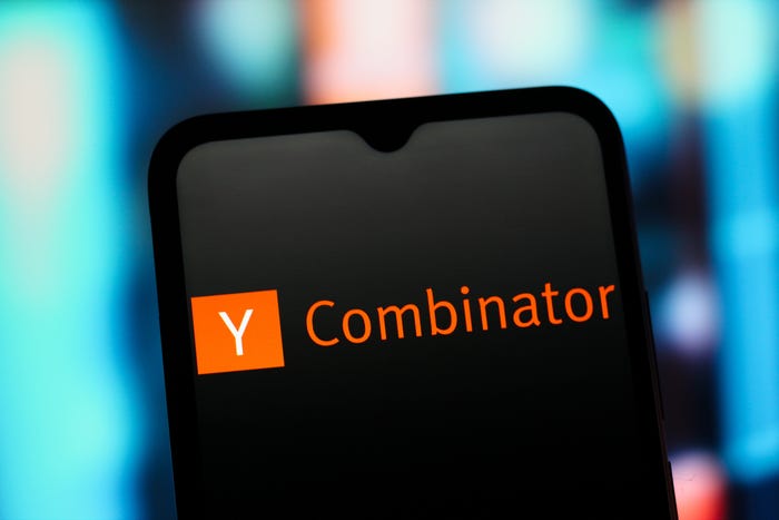 Y Combinator logo with an orange square containing a white 'Y' and orange 'Combinator' text, displayed on a smartphone screen.