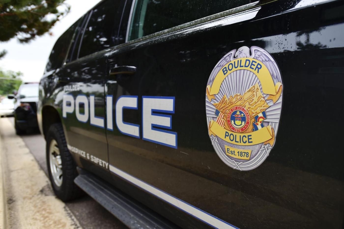 Boulder Police patrol vehicle showing "POLICE" lettering and the official badge on its side.