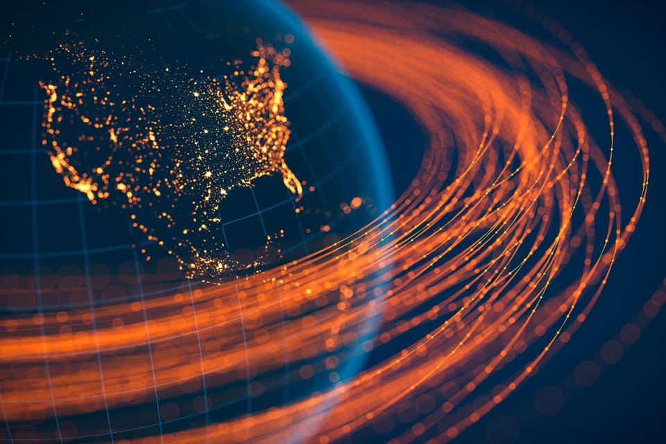 "Globe showing illuminated North America with bright city lights, surrounded by swirling orange data streams."